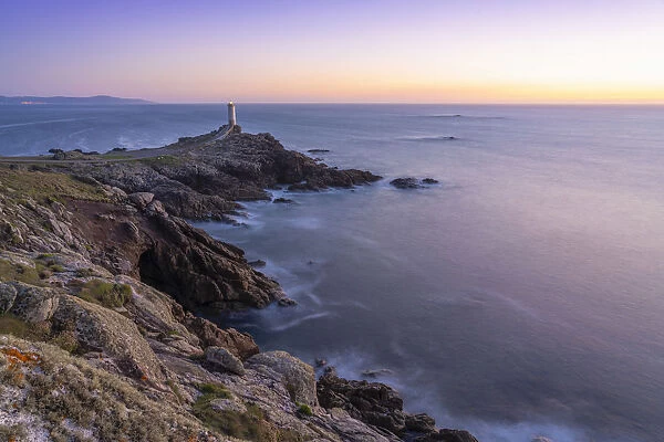 Spain, Galicia, Roncuda, overview of bay and lighthouse at dusk