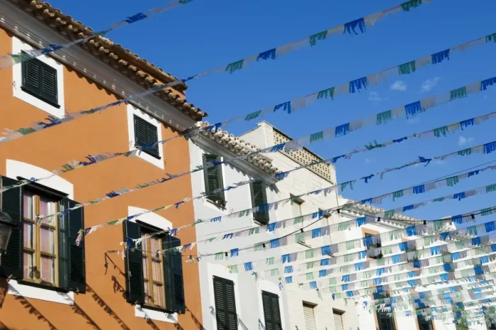 Framed Print : Spain, Menorca. Bunting over a street in Es Mercadal