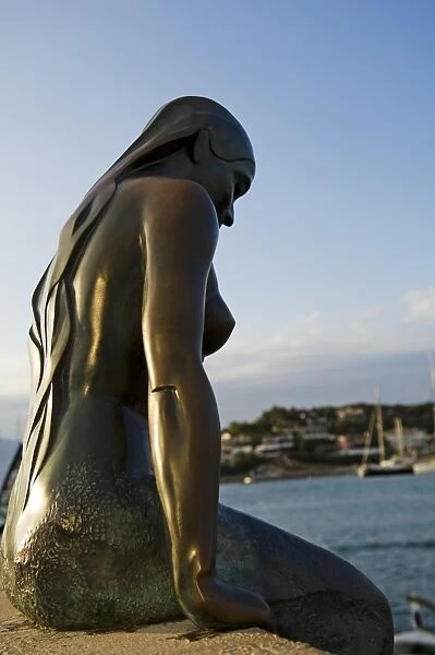 Spain, Menorca, Mahon. Statue of a mermaid looks out over Mahon Harbour