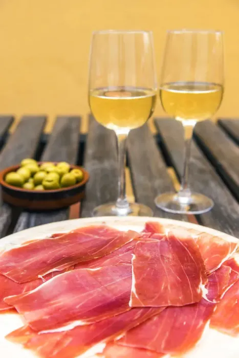 Framed Print : Spanish ham or jamon iberico served with glasses of white wine and olives in a tapas bar Framed Print : Spanish ham or jamon iberico served with glasses of white wine and olives in a tapas bar