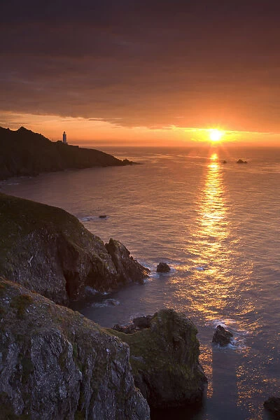 Spectacular sunrise behind Start Point Lighthouse in South Hams, Devon, England. Autumn