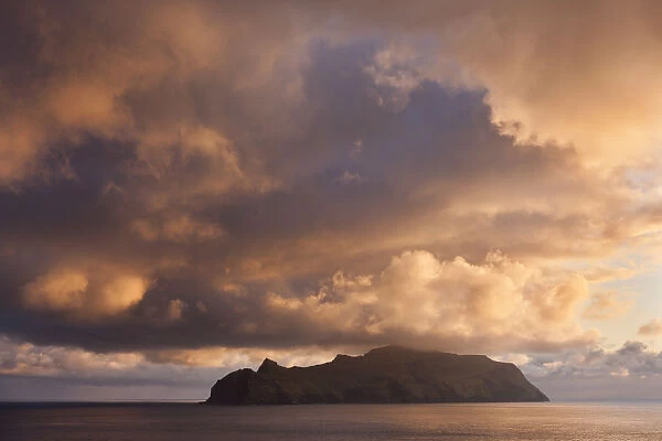Spectacular sunset skies above the island of Mykines, Faroe Islands. Spring