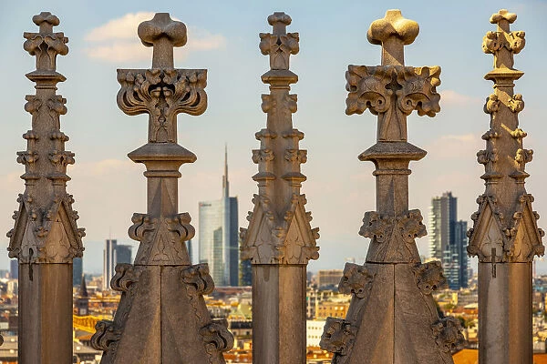 Spiers of Milan Cathedral with modern skyline in background, Lombardy, Italy