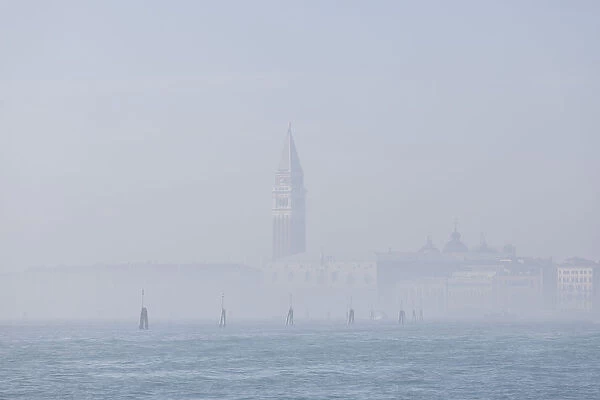 St Marks Bell Tower and Doges Palace in the mist; Venice, Veneto, Italy