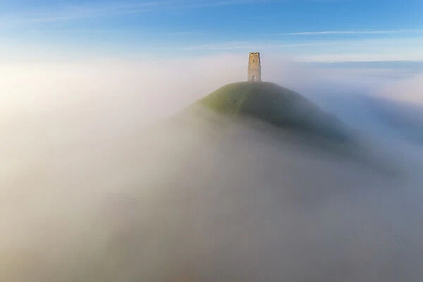 St Michael's Tower on Glastonbury Tor, surrounded by a sea of mist, Glastonbury, Somerset, England. Autumn (November) 2022