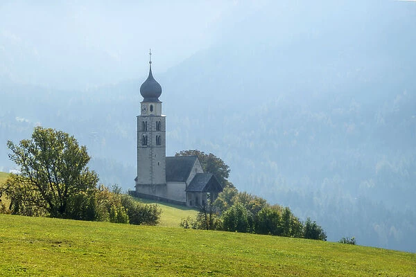 St. Valentines Church in Siusi bathed in the late morning light. Dolomites, Italy