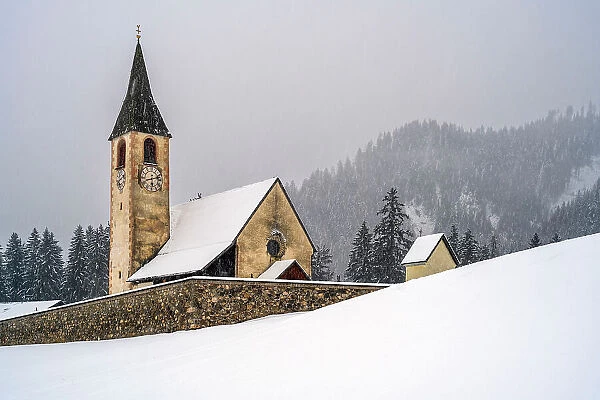 St. Veit church (Chiesa di San Vito) in a scenic snowy landscape, Prags-Braies, South Tyrol, Italy