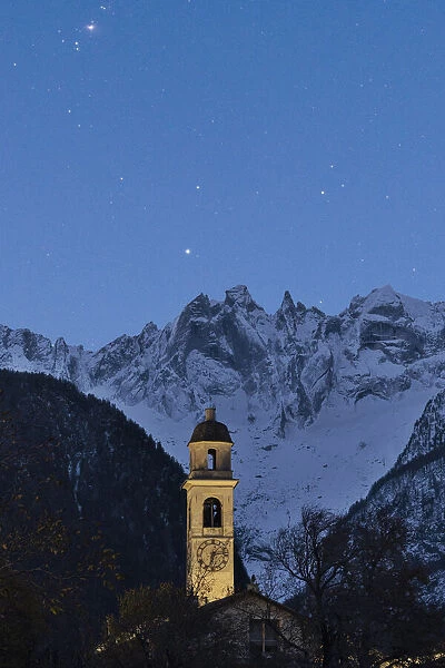 Starry sky over the bell tower and Sciore mountain range, Soglio, Val Bregaglia, Graubunden canton, Switzerland