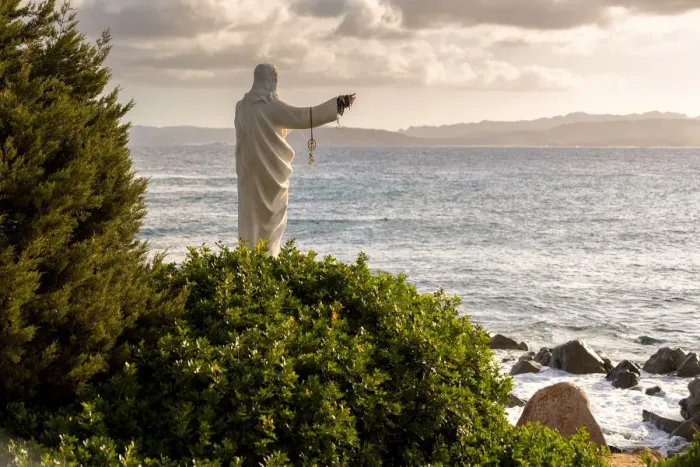 Framed Print : Statue of Christ on the beach, Sardinia, Sassari province, Italy