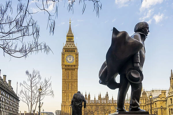 Statue of David Lloyd George, a former British Prime Minister and the Winston Churchill statue in the background. Big Ben, also known as Elizabeth Tower. Part of the Houses of Parliament and a Unesco World Heritage site, London, England, UK