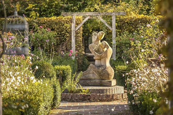 statue in the garden of Les Jardins de Pays d`Auge, Cambremer, Calvados, Normandy, France