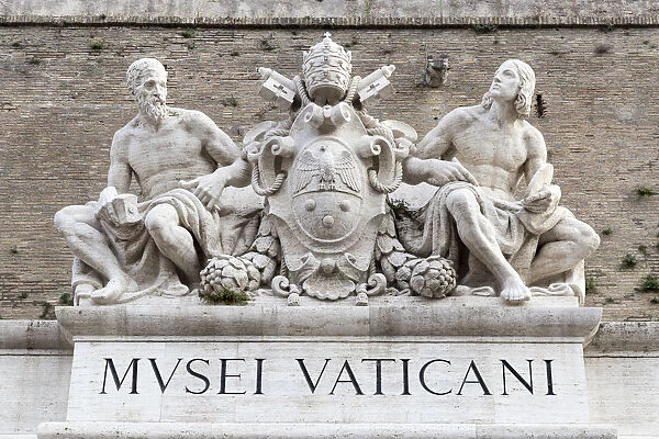 Statues of Michelangelo and Raphael at the main doorway of the Vatican Museums, Rome