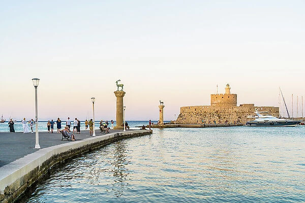 The statues of the Myth Colossus of Rhodes at the Mandraki Marina and Port looking towards Saint Nicholas Fortress, Rhodes Town, Rhodes, Dodecanese Islands, Greece
