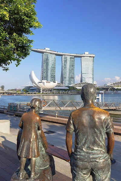 Statues on waterfront and Marina Bay Sands Hotel, Singapore