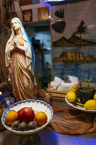 Statuette of the Madonna in a typical restaurant, Naples, Italy