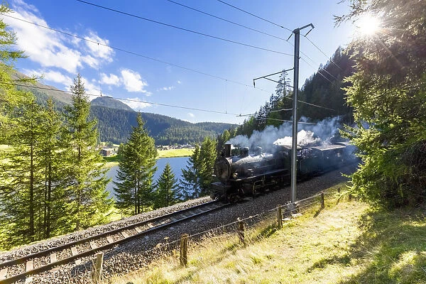 Steam train transits at Schwarzsee, Davos, Albula Valley, Graub√ºnden, Switzerland