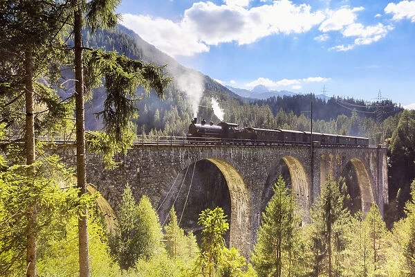 Steam train transits on Wiesen Viaduct, Davos Wiesen, Albula Valley, Graub√ºnden, Switzerland