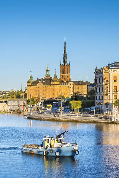 Stockholm, Sweden, Northern Europe. Fishing boat passing in front of Riddarholmen