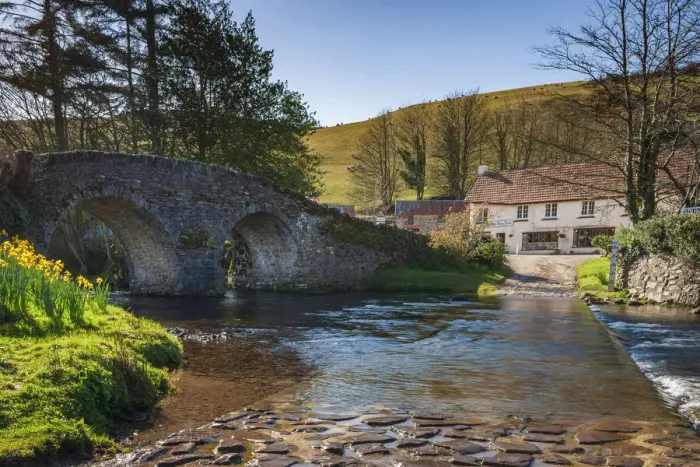 Framed Print : Stone bridge over Badgworthy Water in the picture postcard village of Malmsmead Framed Print : Stone bridge over Badgworthy Water in the picture postcard village of Malmsmead