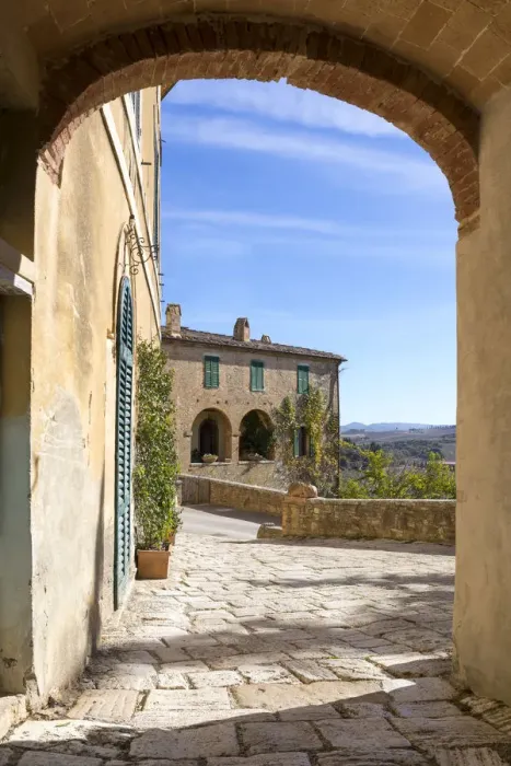 Framed Print : A stone house framed by an arch in the village of Lucignano d Asso, Val Framed Print : A stone house framed by an arch in the village of Lucignano d Asso, Val