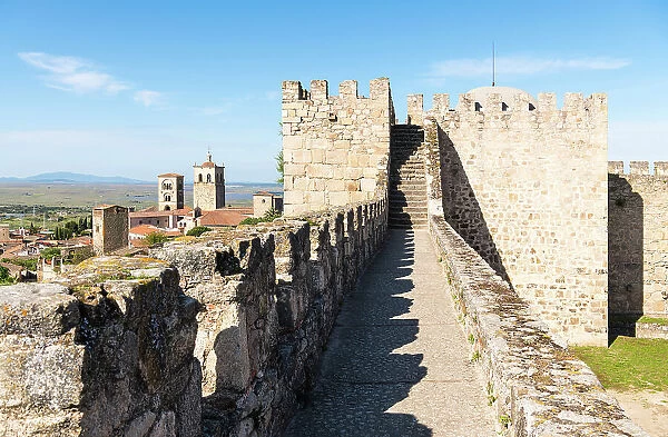 Stone walls of Castillo de Trujillo (Trujillo Castle), with views towards Iglesia de Santa Maria la Mayor (church of Santa Maria la Mayor) on the left, Trujillo Extremadura, Caceres, Spain