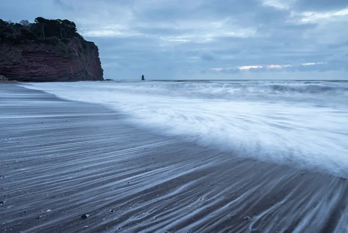 Framed Print : Stormy sunrise on Holcombe Beach in Teignmouth, Devon, England. Winter (February) 2025