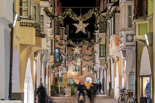 Street adorned with festive Christmas decorations, Brixen-Bressanone, South Tyrol, Italy