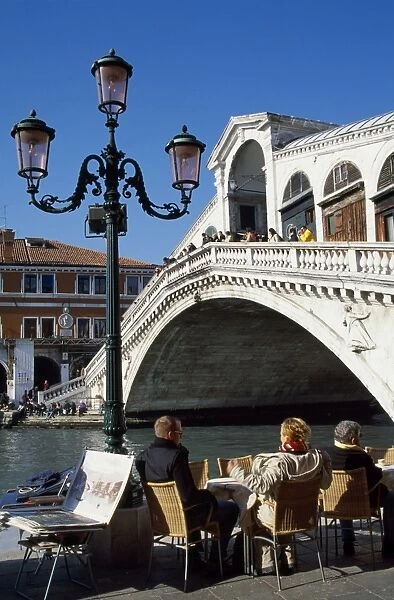 A street cafe overlooking the Gran canal and Rialto Bridge