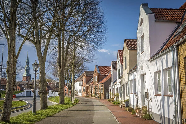 Street at the harbor in Toenning with St. Laurentius Church, North Friesland