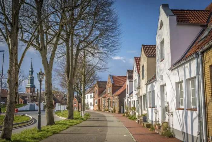 Framed Print : Street at the harbor in Toenning with St. Laurentius Church, North Friesland