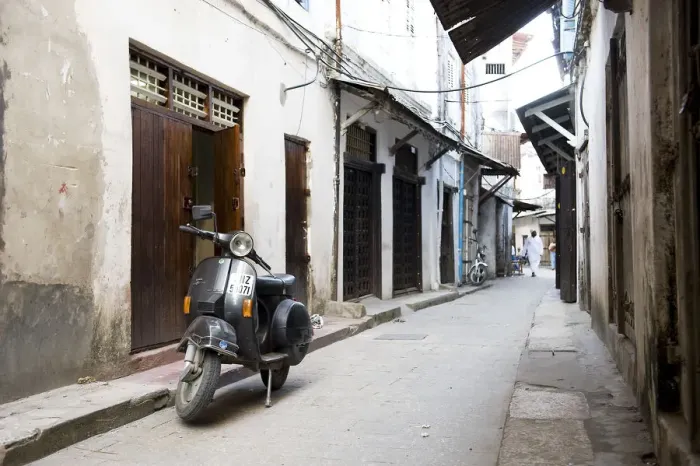 Framed Print : Street scene in Stone Town with moped, Unguja Island, Zanzibar archipelago, Tanzania