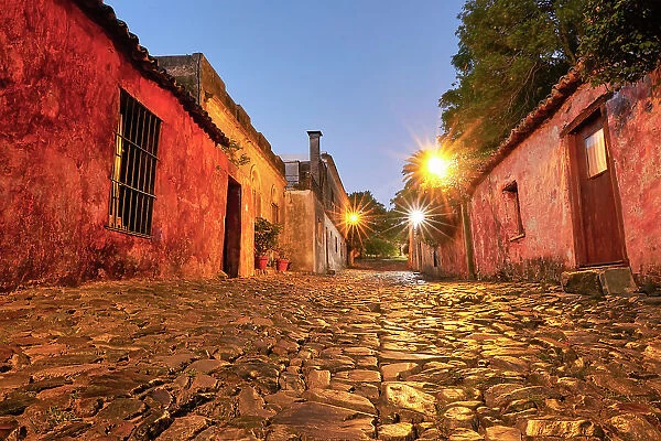 The 'Street of Sighs' (Spanish: Calle de los Suspiros) at twilight, in the historical cask of Colonia de Sacramento, Uruguay. Colonia was declared UNESCO World Heritage Site in 1995