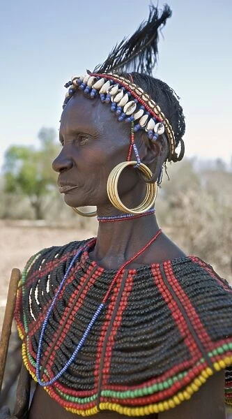 A striking old Pokot woman wearing the traditional beaded ornaments of her tribe which denote her married status. The Pokot are pastoralists speaking a Southern