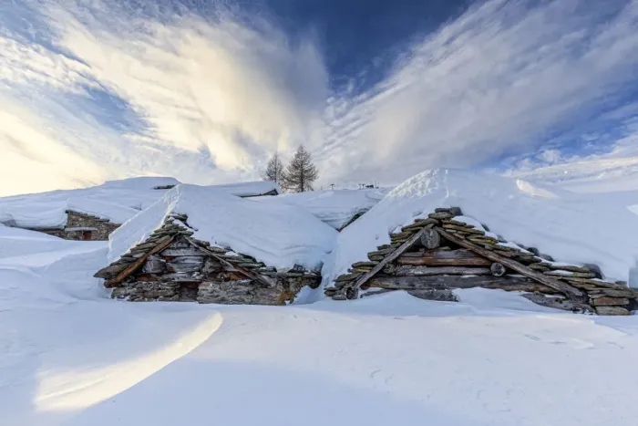 Framed Print : Stunning clouds at sunrise above traditional old huts in winter Framed Print : Stunning clouds at sunrise above traditional old huts in winter
