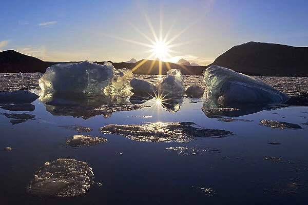 Sun reflecting on the partly frozen surface of Kongsfjord, northern Spitsbergen, Svalbard