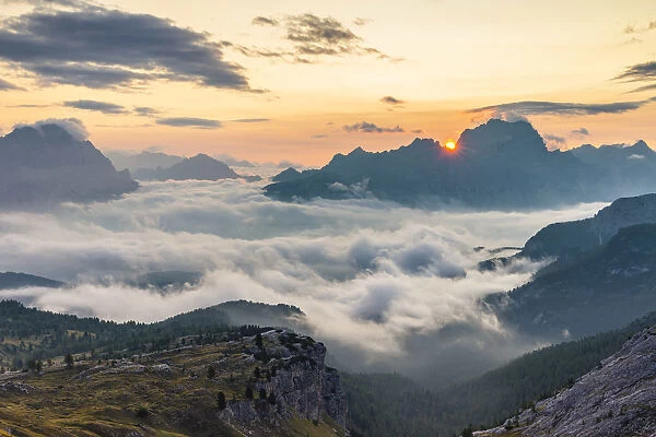 The sun rises in Cortina d Ampezzo hidden by the morning fog, Belluno district