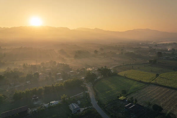 Sun rising over mountains and fields by Lake Inle, Nyaungshwe Township, Taunggyi District