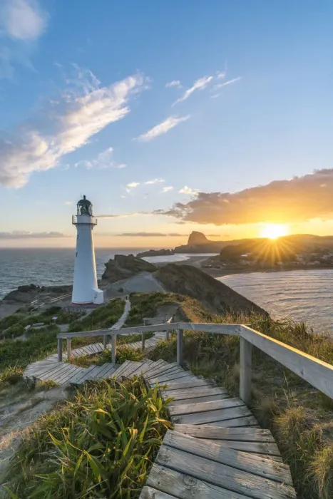 Framed Print : The sun is setting down behind Castle Rock and Castlepoint lighthouse. Castlepoint