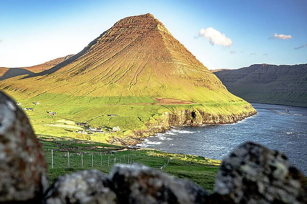 Sunlight ovet Vidareidi village and majestic Malinsfjall mountain, Vidoy Island, Faroe Islands