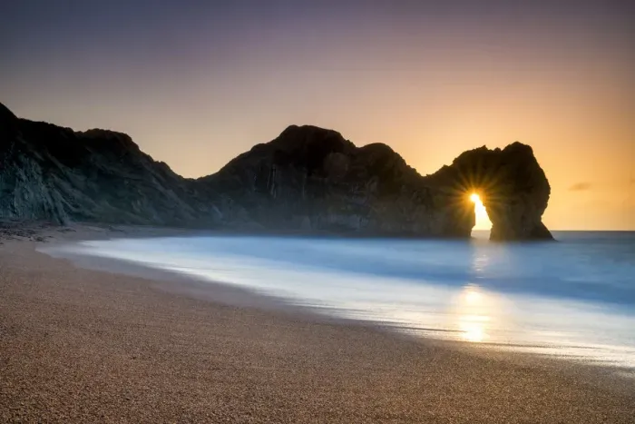 Framed Print : Sunrise Through Durdle Door, Dorset, England Framed Print : Sunrise Through Durdle Door, Dorset, England