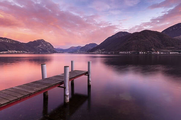 Sunrise explosion of colors in front of Lugano and Campione d