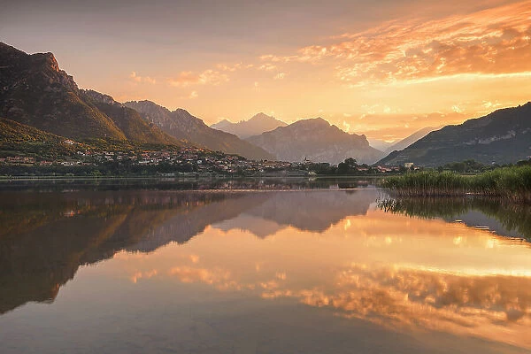 Sunrise on lake Annone with Lecco mountains reflected, Brianza, Lecco province, Lombardy, Italy