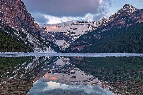 Sunrise at Lake Louise. Victoria Glacier on Mt. Victoria. Fairview Mountain onthe left and Mt. Whyte on the right, Banff National Park, Alberta, Canada