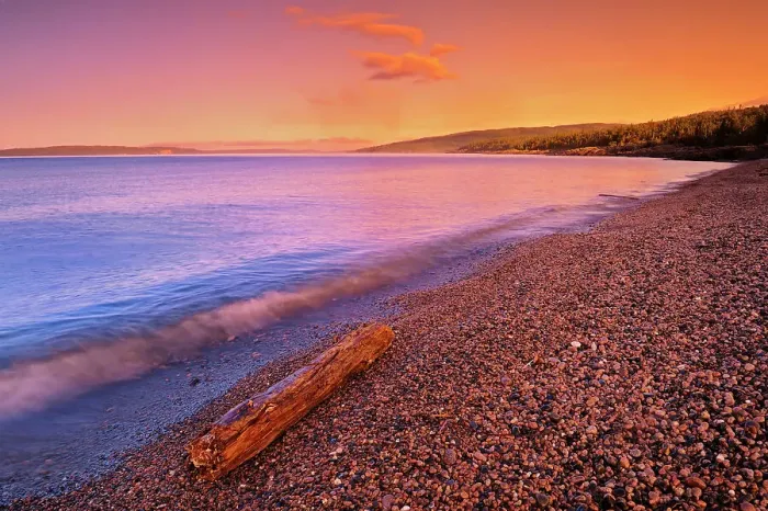 Framed Print : Sunrise on pebble beach of Lake Superior with driftwood Schreiber, Ontario, Canada