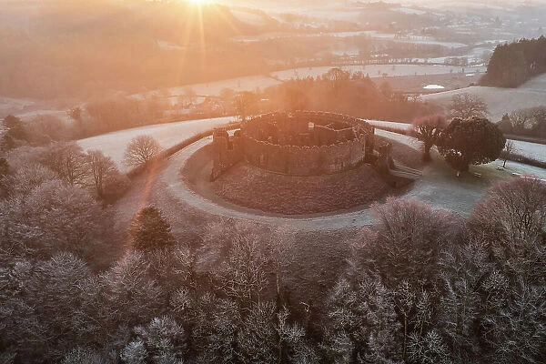Sunrise over Restormel Castle on a chill, frosty morning, Lostwithiel, Cornwall, England. Winter (January) 2023