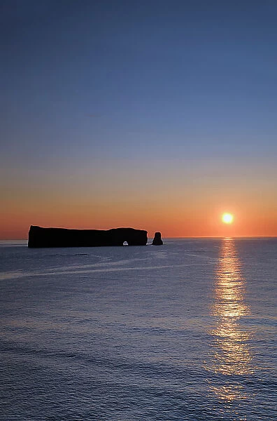 SUnrise and Rocher perce (Perce Rock) on the Atlantic Ocean Perce Quebec, Canada