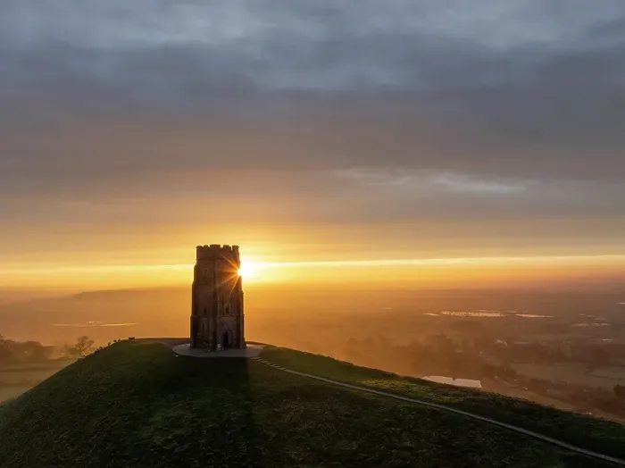 Framed Print : Sunrise behind St Michaels Tower on Glastonbury Tor, Somerset, England. Winter (February) 2024