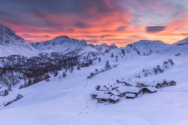 Sunset on the alpine village of Grevasalvas after a snowfall, Engadine