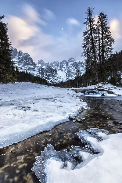 Sunset on a frozen creek. Venagia Valley Panaveggio Natural Park Dolomites Trentino