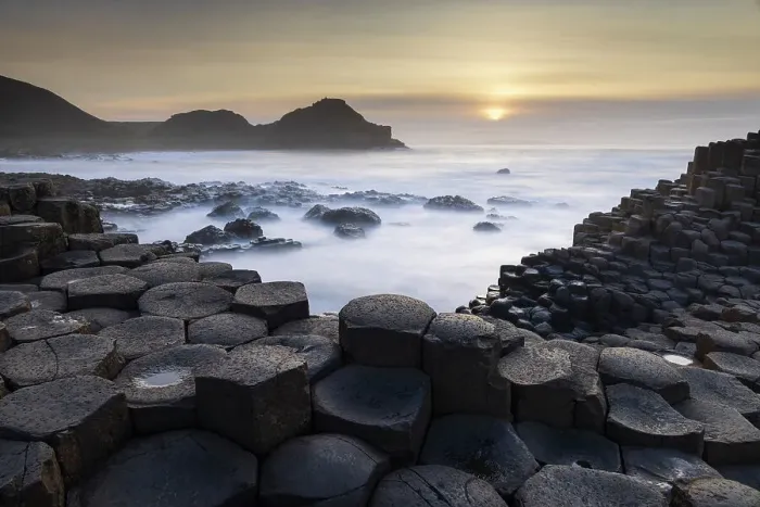 Framed Print : Sunset over the Giant's Causeway on the Causeway Coast, County Antrim, Northern Ireland. Spring (March) 2024